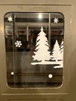 Chrismas themed decorations on an Arnine window